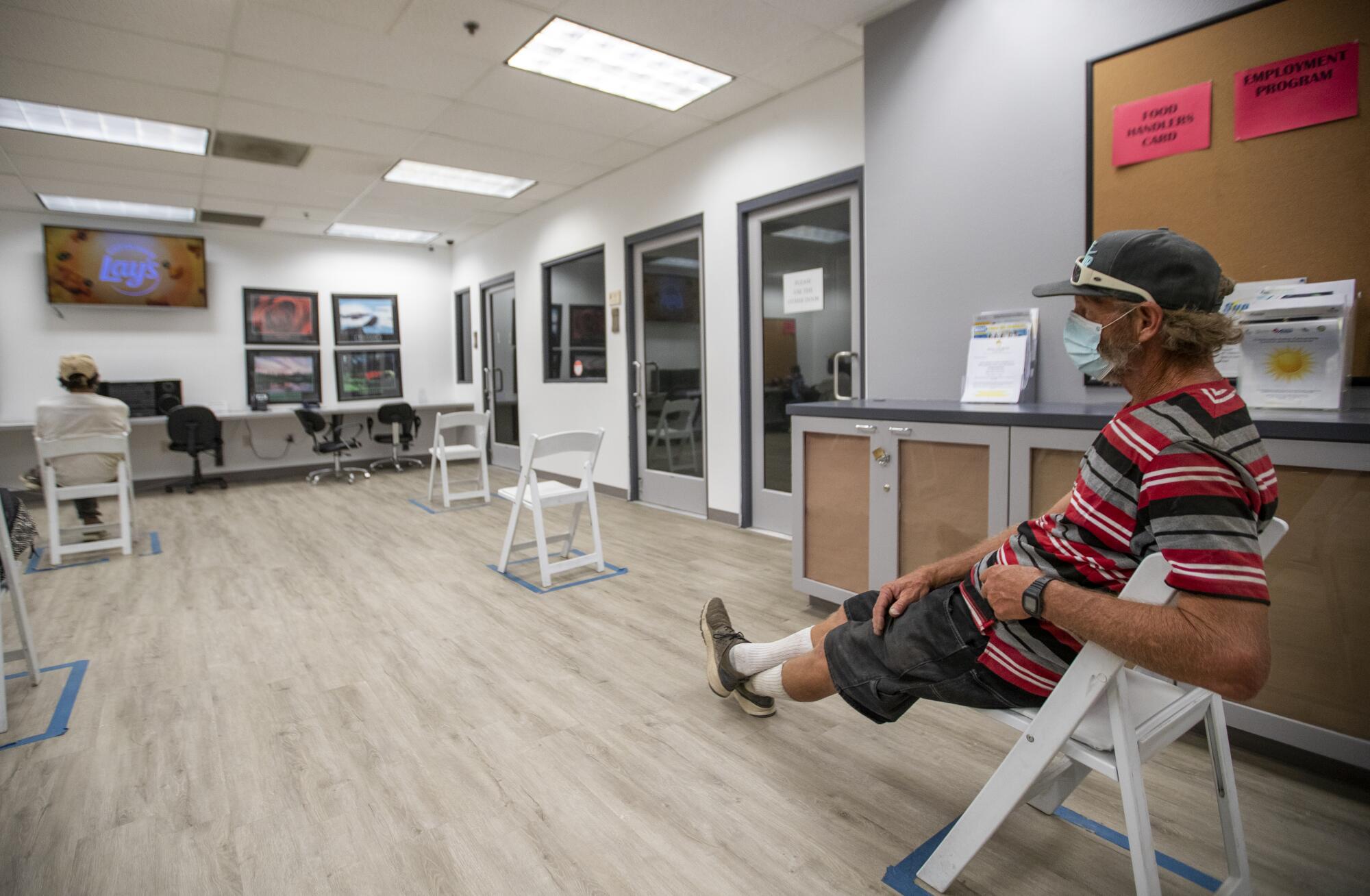 Gregory Newland escapes 109-degree heat watching a movie in the air-conditioned cooling center at Martha's Village & Kitchen