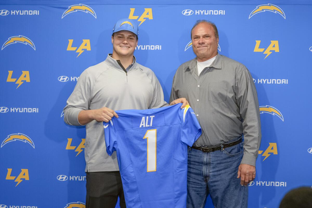 Chargers first-round draft pick Joe Alt, left, stands next to his father, John Alt, during a news conference in Costa Mesa.