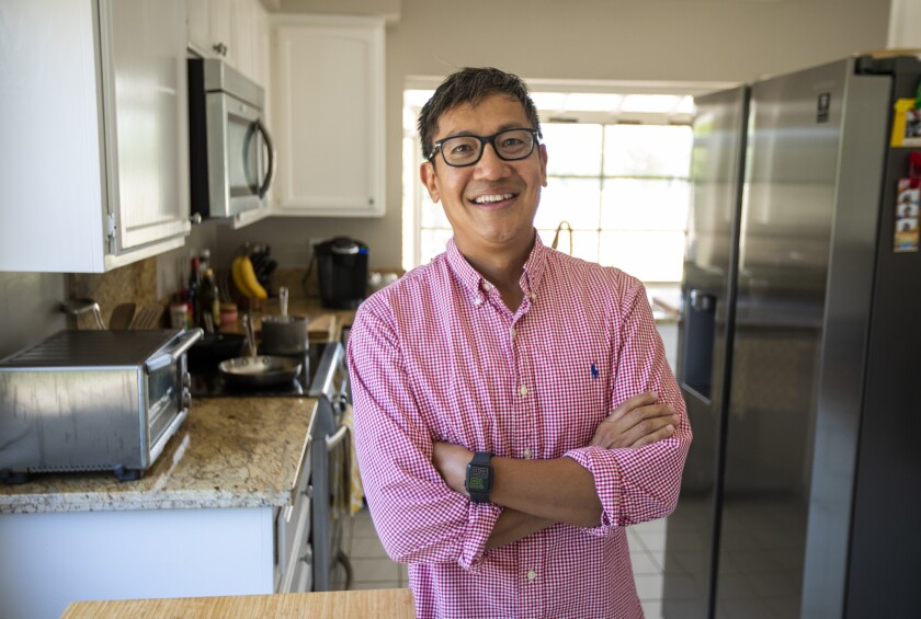 Foo Nguyen stands inside his home in Irvine on Friday, June 17. 