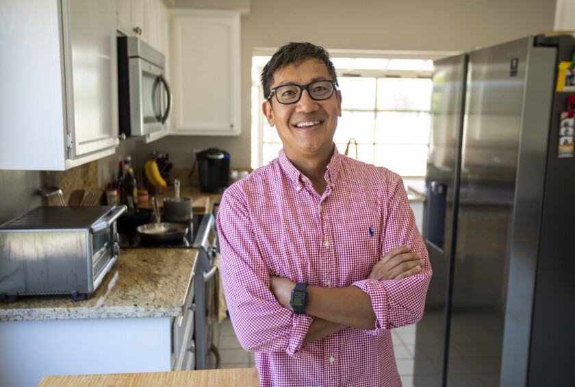 Foo Nguyen stands inside his home in Irvine on Friday, June 17.