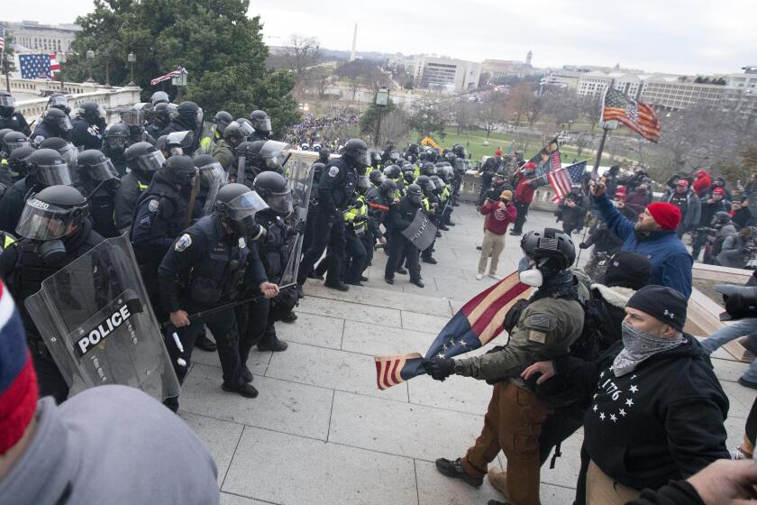 U.S. Capitol Police push back demonstrators who were trying to enter the U.S. Capitol on Wednesday, Jan. 6, 2021, in Washington. (AP Photo/Jose Luis Magana)