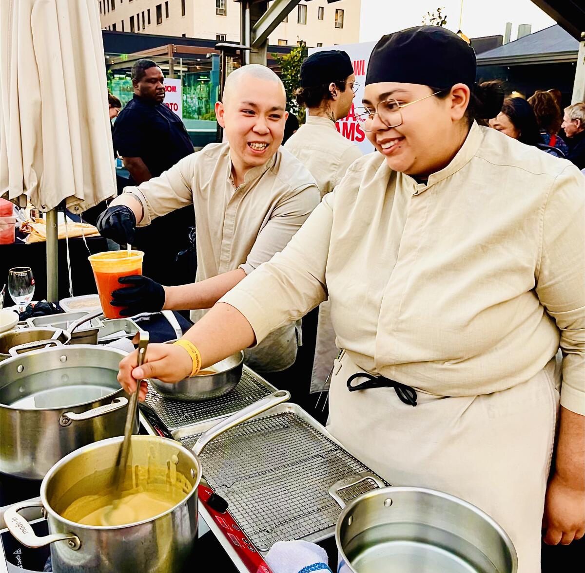 Two chefs cooking at a rooftop restaurant