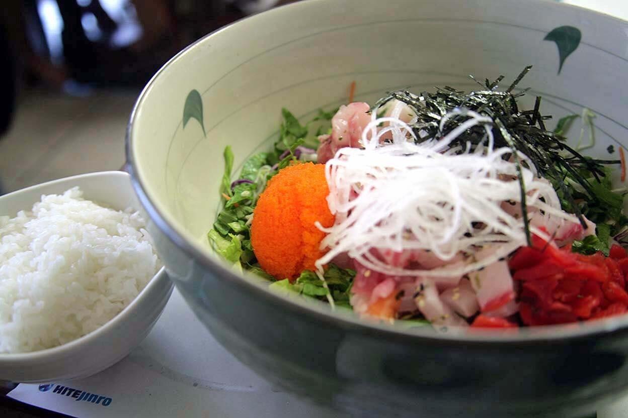Hwaedupbap literally means rice covered in hwae (raw fish) is a bowl of assorted raw fish, chopped curly leaf lettuce, shredded radish, gim (roasted seaweed sheets) and roe.