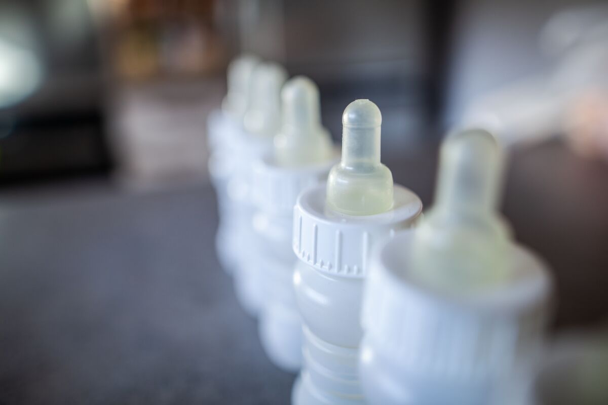 A line of baby bottles on a counter