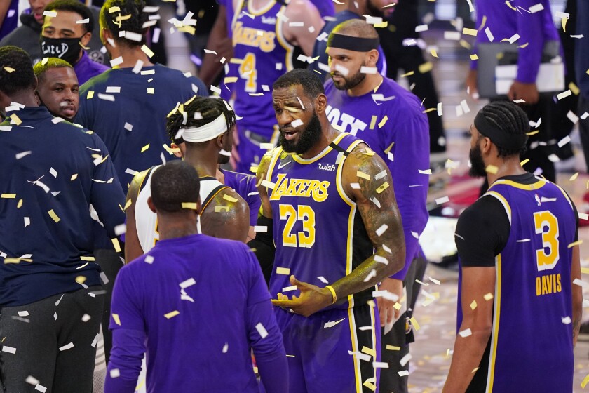 Lakers star LeBron James speaks with players after the Lakers' series-clinching win.