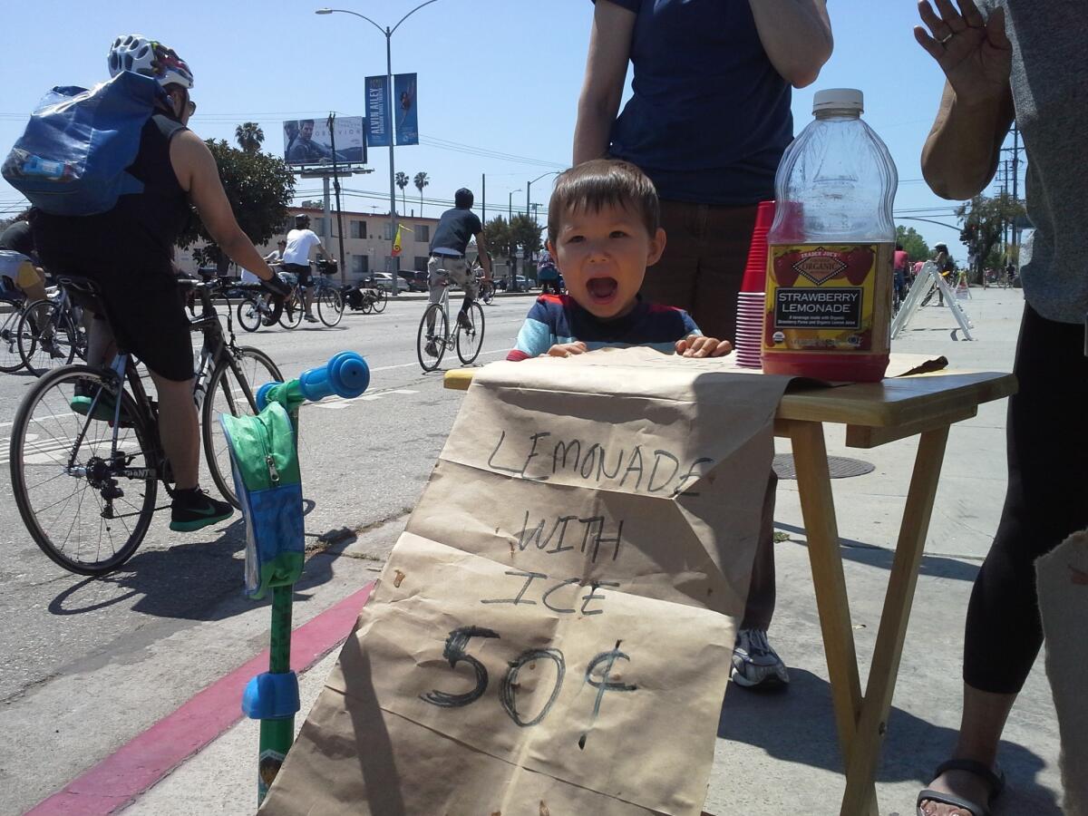 Marcus Wang, 2, at his lemonade stand set up for CicLAvia.