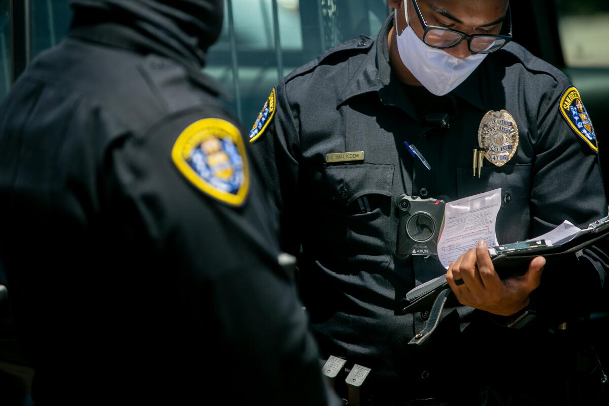 San Diego Police Department officers outfitted with body cameras make a traffic stop along El Cajon Boulevard.