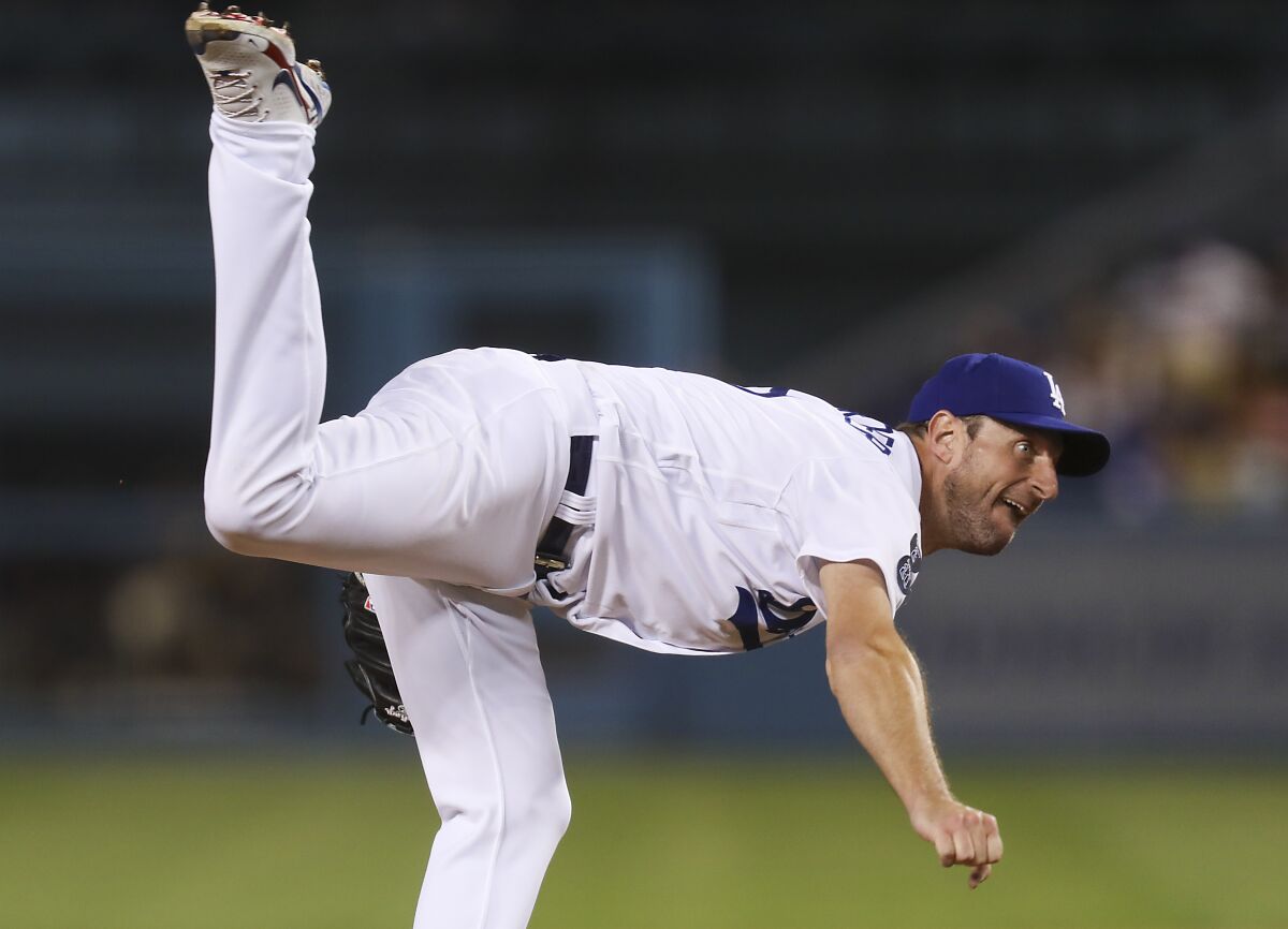Dodgers pitcher Max Scherzer follows through as he delivers a pitch against the San Diego Padres.