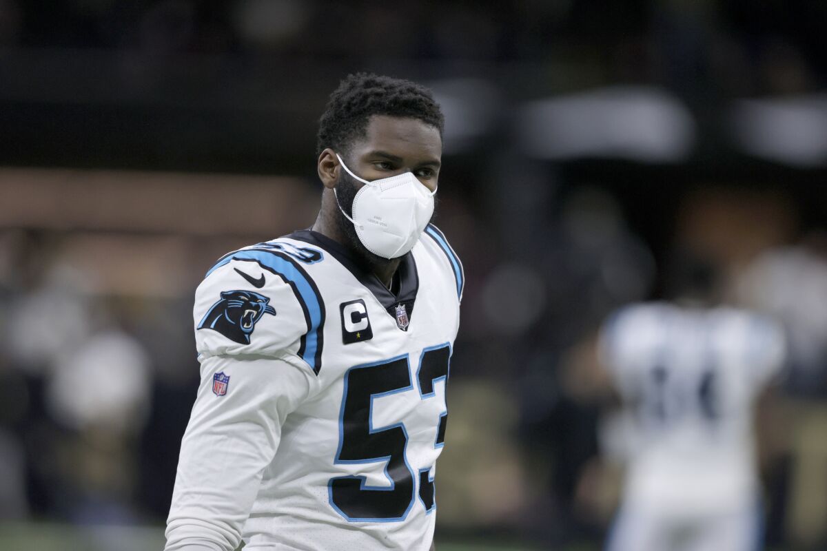 FILE - Carolina Panthers defensive end Brian Burns (53) wears a mask as he warms up before an NFL football game against the New Orleans Saints in New Orleans, Sunday, Jan. 2, 2022. The NFL has suspended all aspects of its COVID-19 protocols, citing recent trends showing that the spread of the coronavirus is declining. In an agreement with the players' association, the league sent a memo to the 32 teams Thursday, March 3, 2022, in which it mentioned “encouraging trends regarding the prevalence and severity of COVID-19, the evolving guidance from the CDC, changes to state law and the counsel of our respective experts” as reasons for the move.(AP Photo/Butch Dill, File)