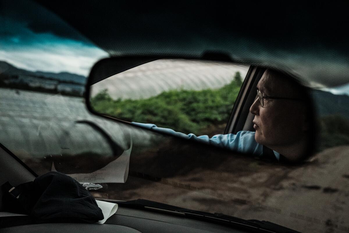 Kim Dal-sung drives around looking for illegal housing on farms in Pocheon, South Korea.