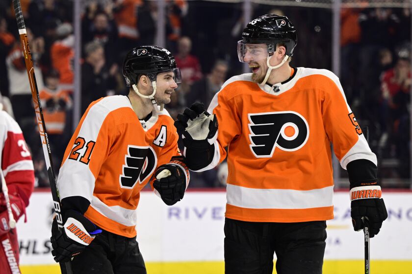 Philadelphia Flyers' Scott Laughton, left, celebrates his goal with Rasmus Ristolainen during the second period of an NHL hockey game against the Detroit Red Wings, Saturday, March 25, 2023, in Philadelphia. (AP Photo/Derik Hamilton)