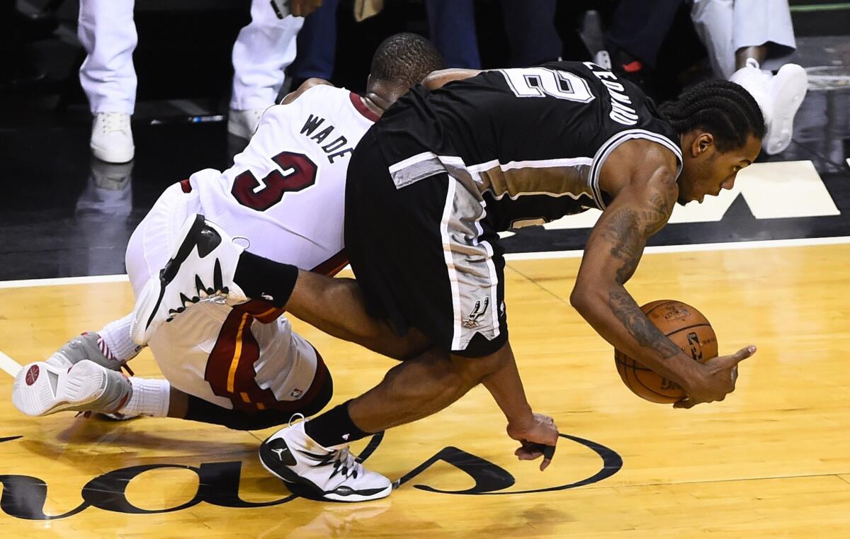 Spurs forward Kawhi Leonard makes one of his three steals against Miami's Dwyane Wade in Game 4 of the NBA Finals.