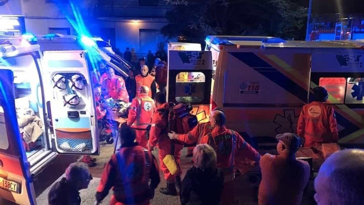 Rescuers help the injured outside a disco in Corinaldo, Italy, early Saturday.