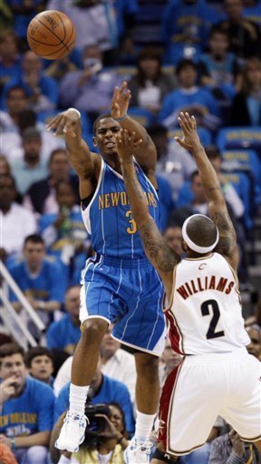New Orleans Hornets guard Chris Paul, left, passes over the reach of Cleveland Cavaliers guard Mo Williams (2) during the first quarter of an NBA basketball game in New Orleans, Saturday, Nov. 1, 2008. (AP Photo/Ann Heisenfelt)