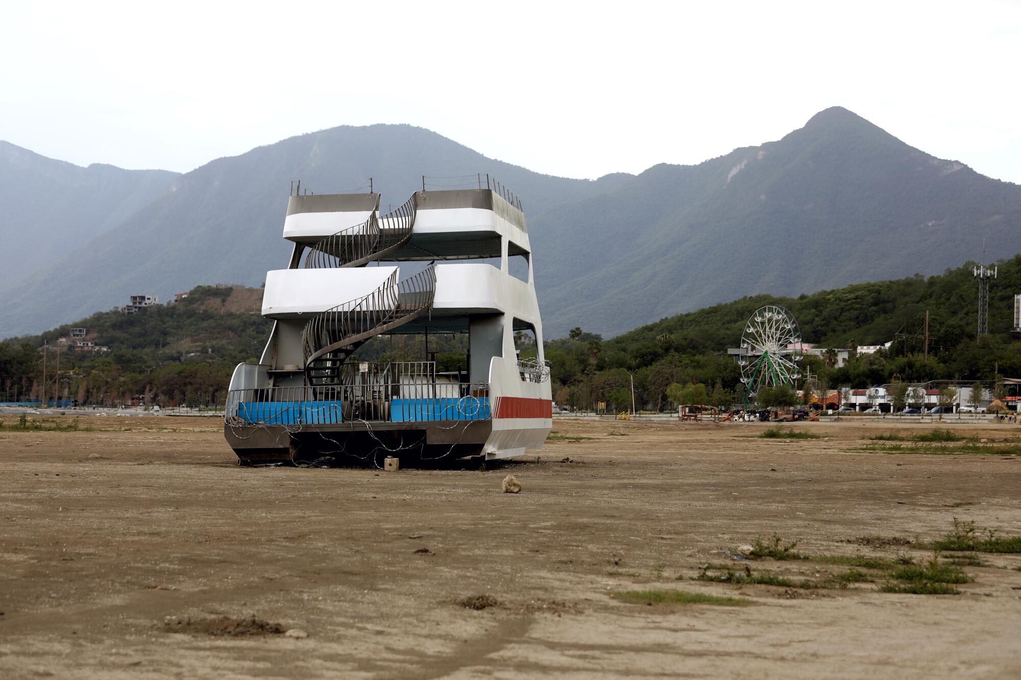 A  boat is stranded on ground where water would normally be.