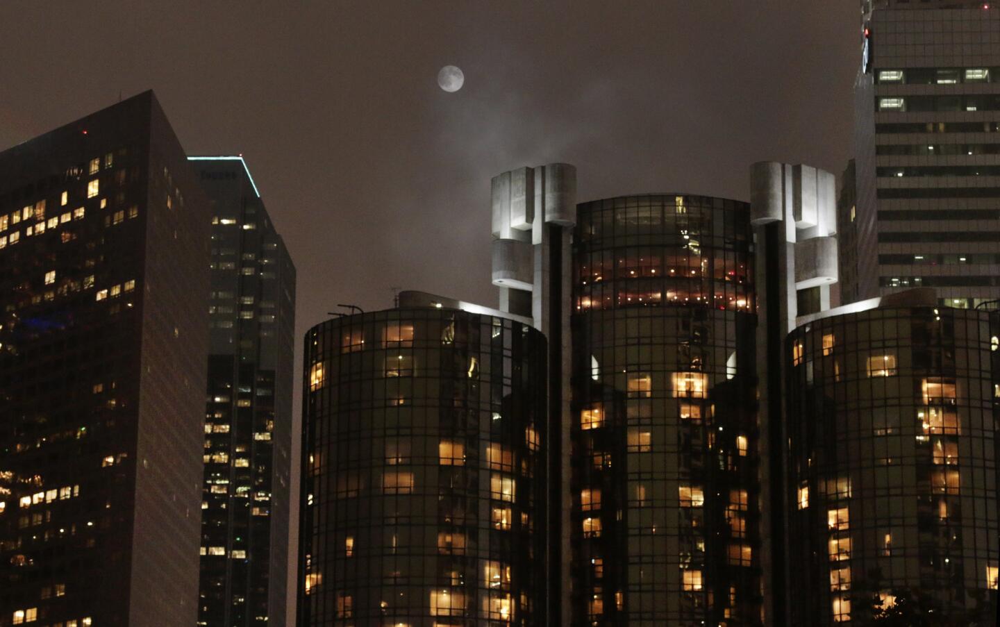An overcast moonrise over downtown Los Angeles, the night before supermoon.
