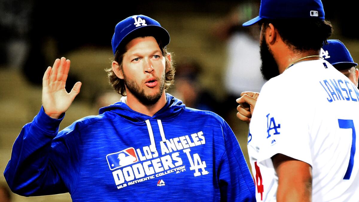Dodgers ace Clayton Kershaw high-fives closer Kenley Jansen after a win over the Giants on Tuesday.
