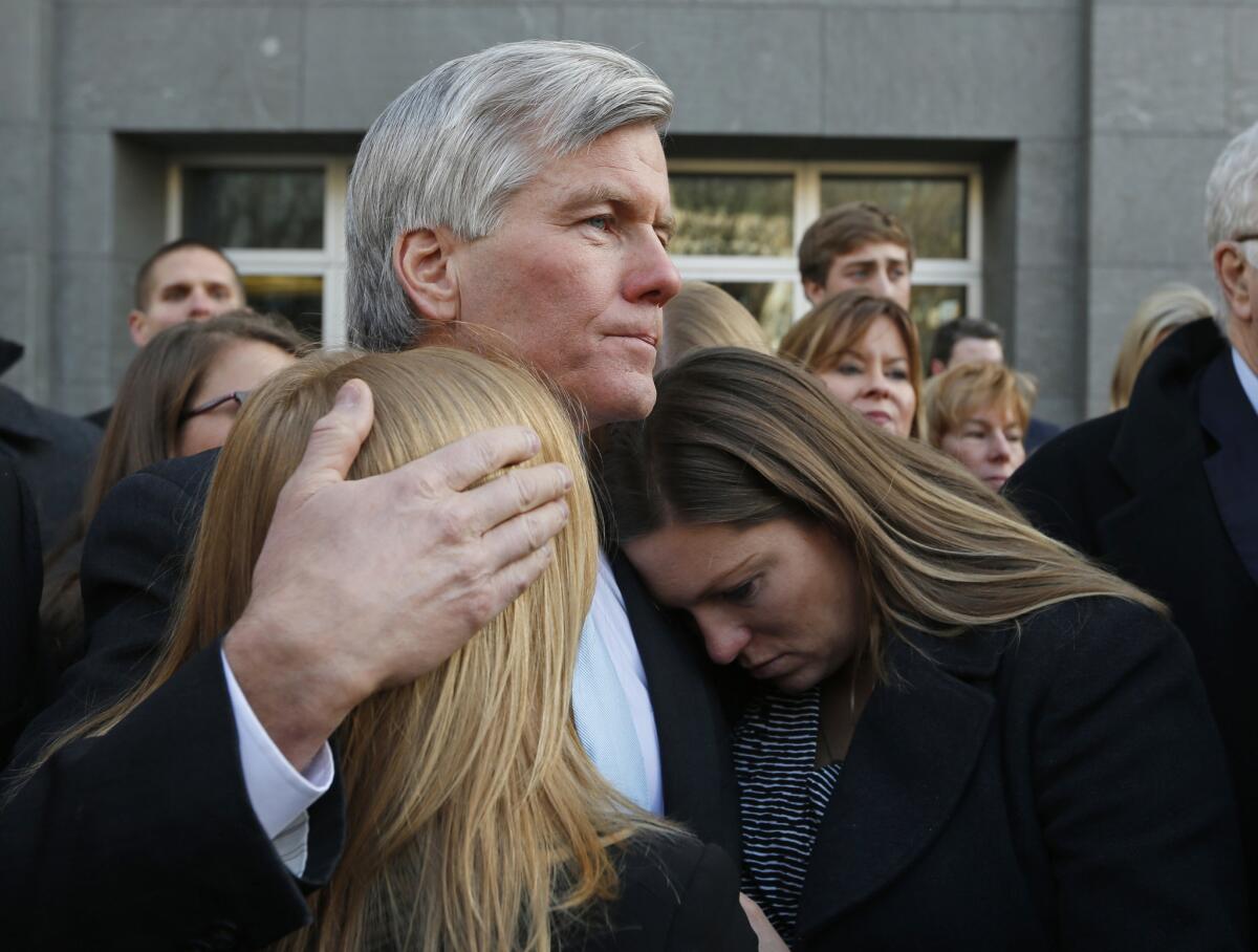 Former Virginia Gov. Bob McDonnell hugs daughters Cailin Young, left, and Jeanine McDonnell Zubowsky after his sentencing for bribery and corruption in Richmond, Va., in January 2015.