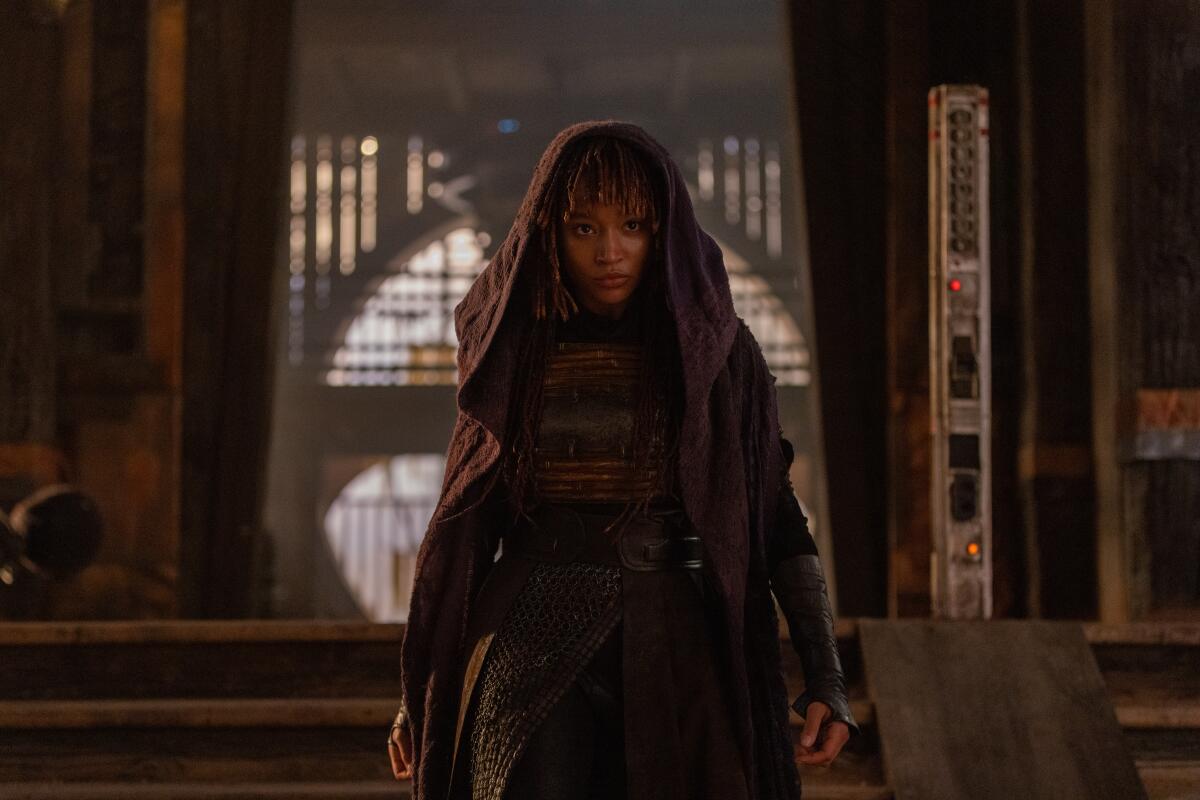 Amandla Stenberg in a hooded cape