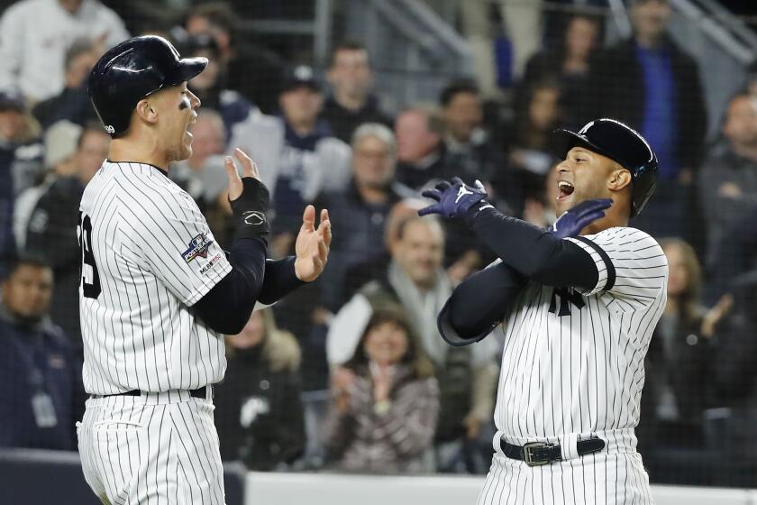 Mandatory Credit: Photo by JUSTIN LANE/EPA-EFE/REX (10450234p) New York Yankees batter Aaron Hicks (R) celebrates with teammate Aaron Judge (L) after hitting a three-run home run in the bottom of the first inning of their MLB American League Championship Series playoff baseball game five at Yankee Stadium in the Bronx, New York, USA, 18 October 2019. The winner of the seven game playoff series will go on to face the Washington Nationals in the World Series. Houston Astros at New York Yankees, Bronx, USA - 18 Oct 2019 ** Usable by LA, CT and MoD ONLY **