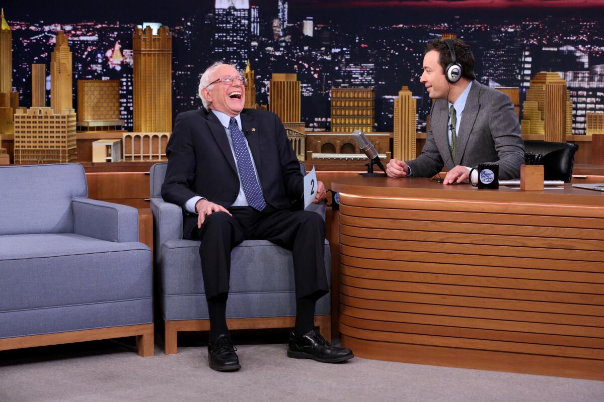 Sen. Bernie Sanders laughs on "The Tonight Show" set with Jimmy Fallon