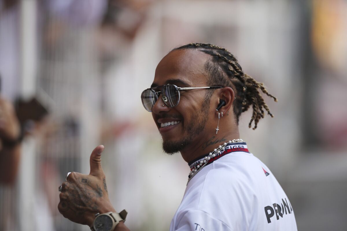 Mercedes driver Lewis Hamilton of Britain thumbs up as he arrives for driver's parade ahead the Monaco Formula One Grand Prix, at the Monaco racetrack, in Monaco, Sunday, May 29, 2022. (AP Photo/Daniel Cole)