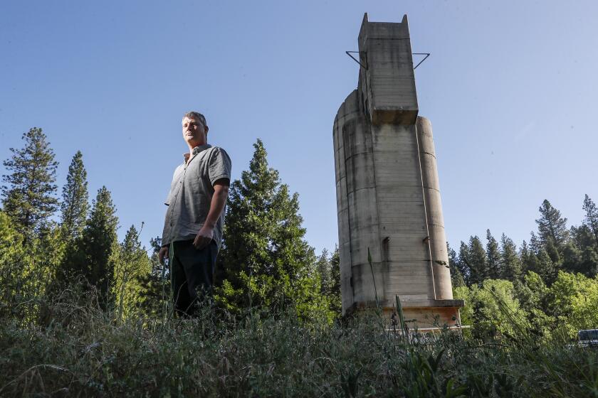 Nevada City, CA, Tuesday, June 6, 2022 - Ben Mossman, CEO of Rise Gold Corporation, poses for a photo near a silo on the grounds of the shuttered Idaho Maryland gold mine. (Robert Gauthier/Los Angeles Times)