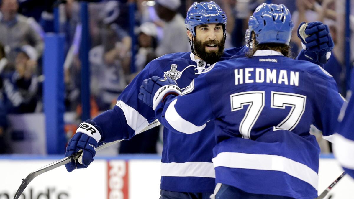 Lightning defenseman Jason Garrison, left, celebrates his game-winning goal with teammate Victor Hedman in the third period of Game 2 against the Blackhawks on Saturday in Tampa.