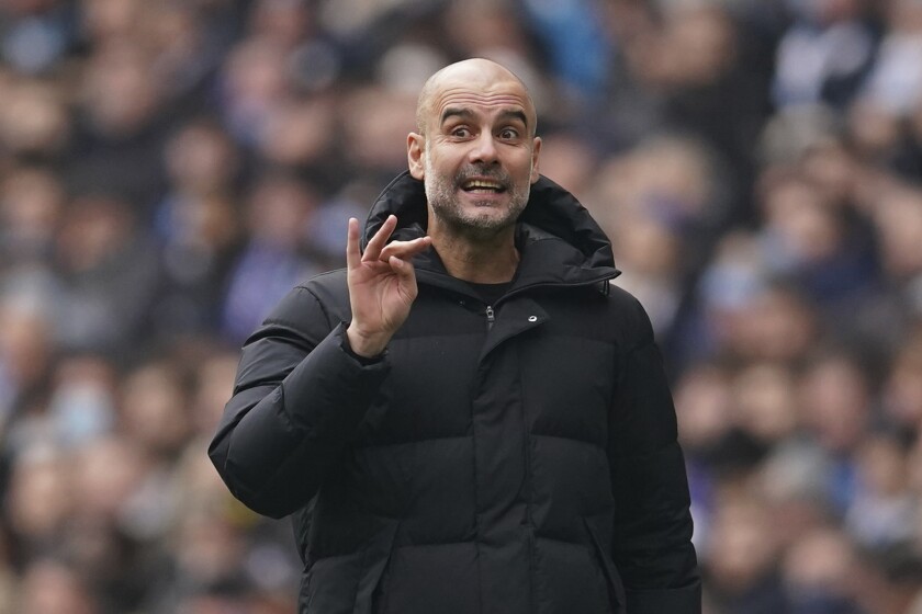 Manchester City's head coach Pep Guardiola gestures during an English Premier League soccer match between Manchester City and Chelsea at the Etihad stadium in Manchester, England, Saturday, Jan. 15, 2022. (AP Photo/Dave Thompson)