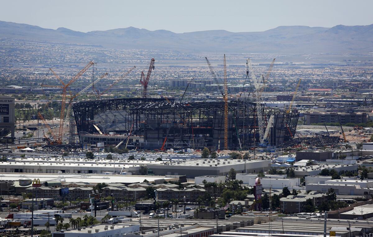 Construction cranes surround the football stadium under construction last month in Las Vegas.