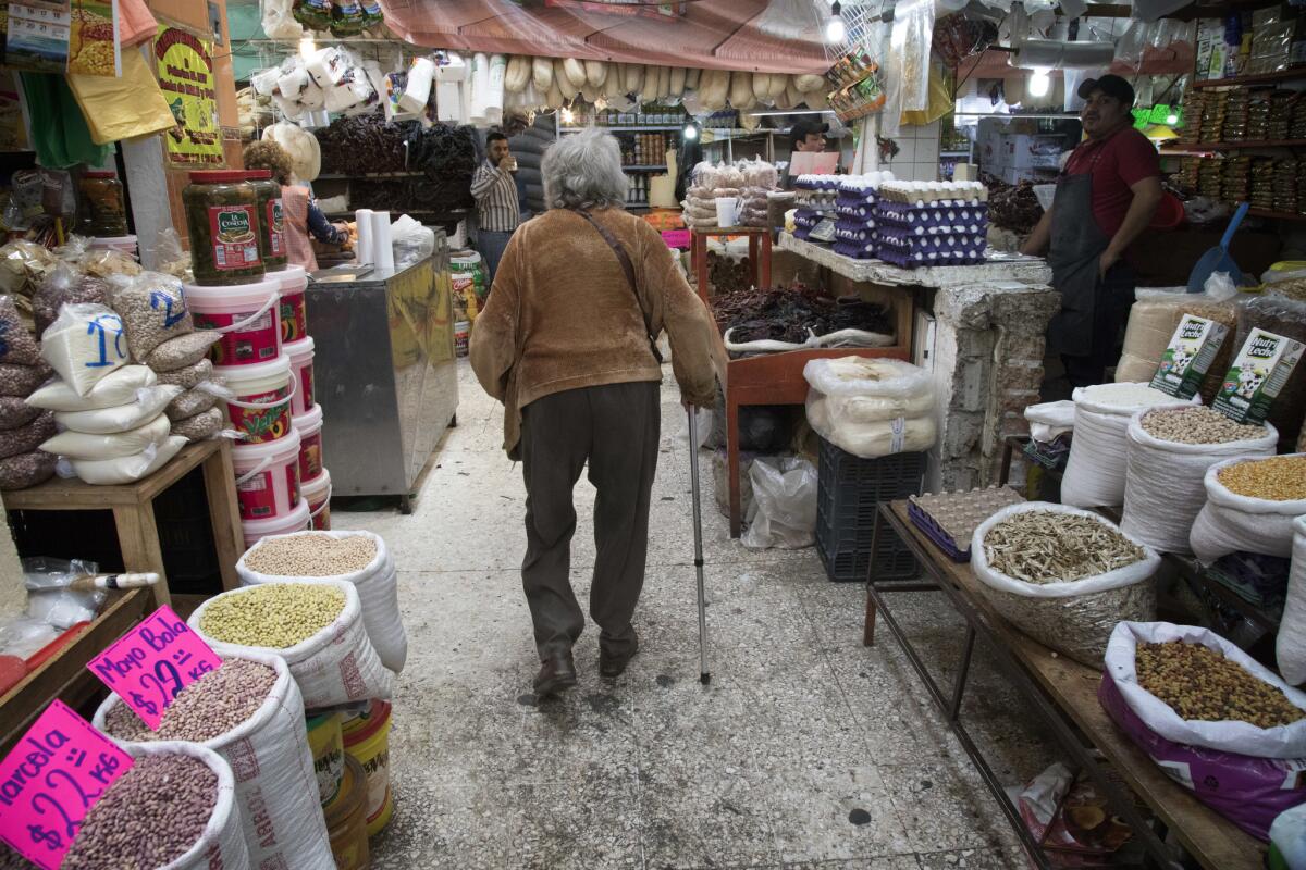 Cookbook author Diana Kennedy walks through the Central Market in Zitacuaro, Mexico. (Ricardo DeAratanha / Los Angeles Times)
