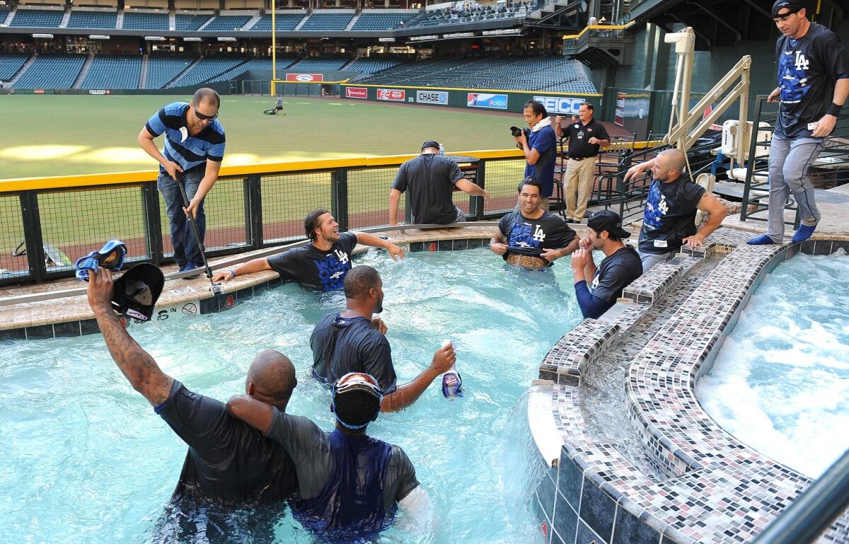 The Dodgers celebrate in the Arizona Diamondbacks' pool after winning the NL West Division title on Thursday.