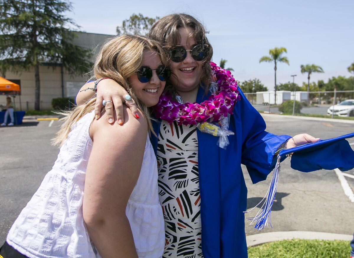 Sami Peterson hugs Amelia Bohn during the graduation celebration at Valley Vista High School on Wednesday.
