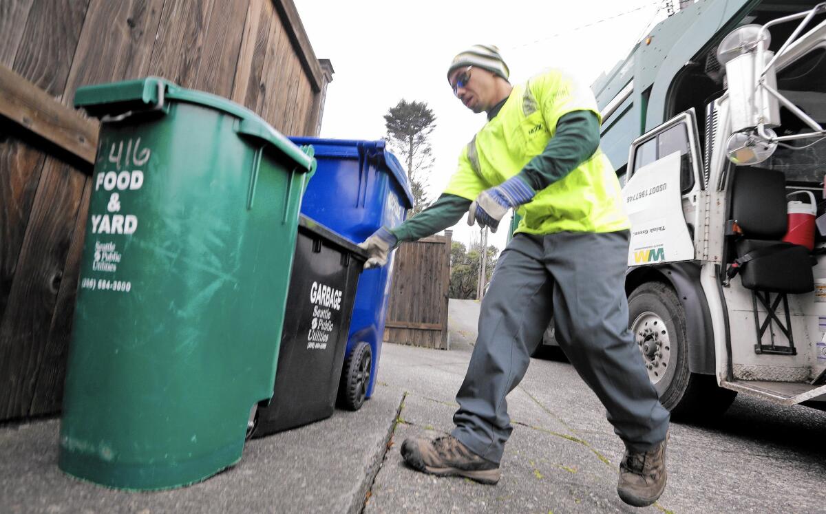 Trash bins in Seattle are checked for proper separation of recyclables.