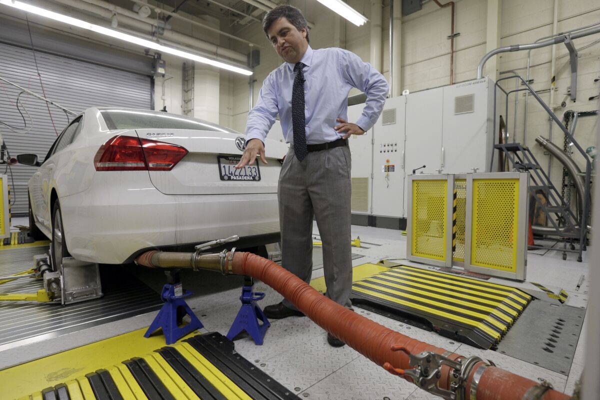 John Swanton, spokesman with the California Air Resources Board, explains how a 2013 Volkswagen Passat with a diesel engine is evaluated at the emissions test lab in El Monte, Calif., in this Sept. 30 photo.
