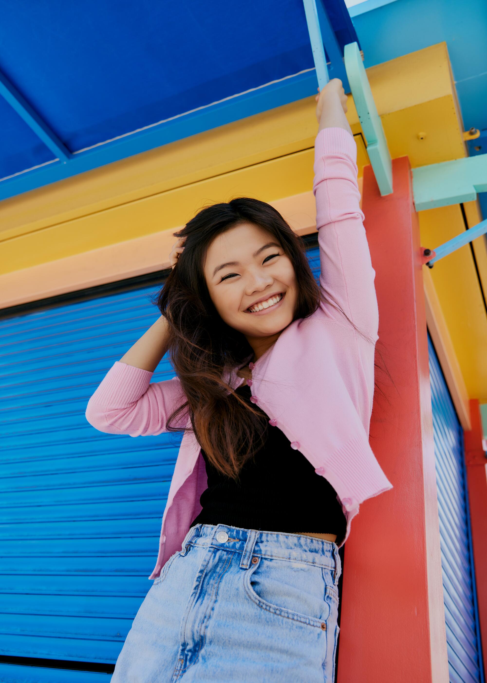 Miya Cech smiles against a colorful structure in Little Tokyo.