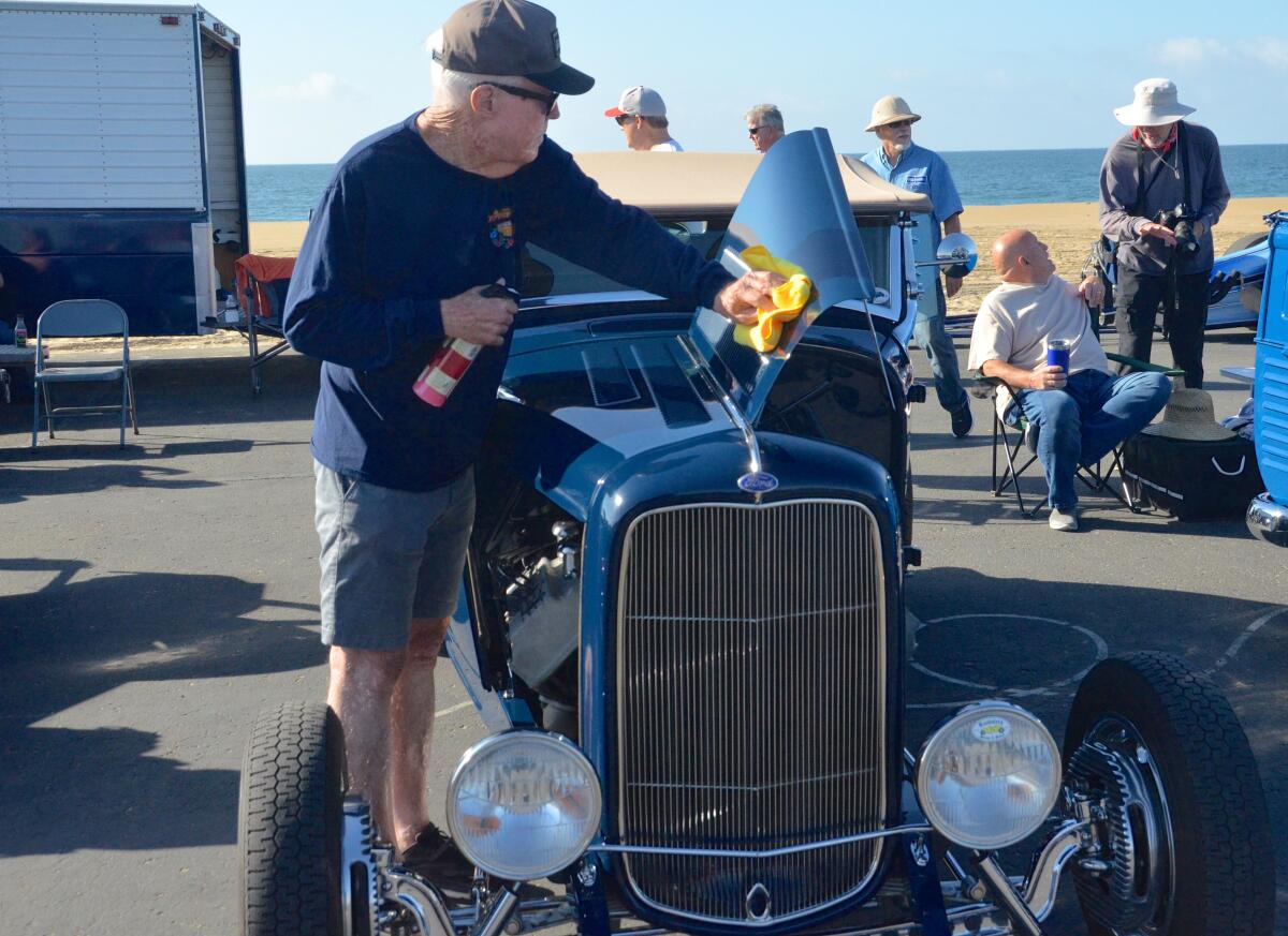 Gary Boler polishes his 1932 Ford Roadster at the Newport Beach Classic Car-Truck Festival.