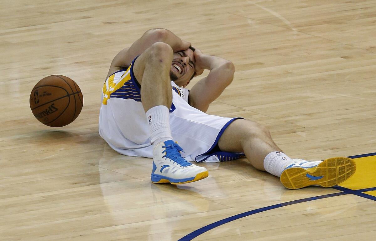 Golden State guard Klay Thompson lies on the court after being injured during the fourth quarter Wednesday against Houston.