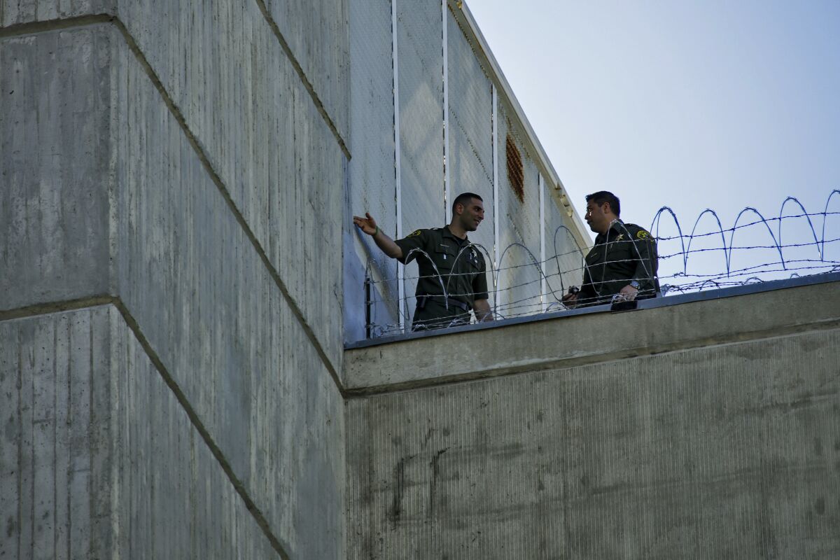 Orange County Sheriff investigators check out the roof of Central Men's Jail in 2016 after three inmates escaped.