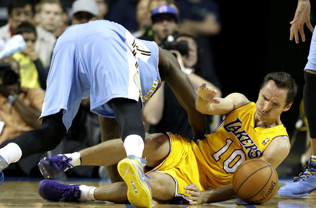 Lakers point guard Steve Nash and Nuggets guard Randy Foye battle for a loose ball during a preseason game Tuesday.