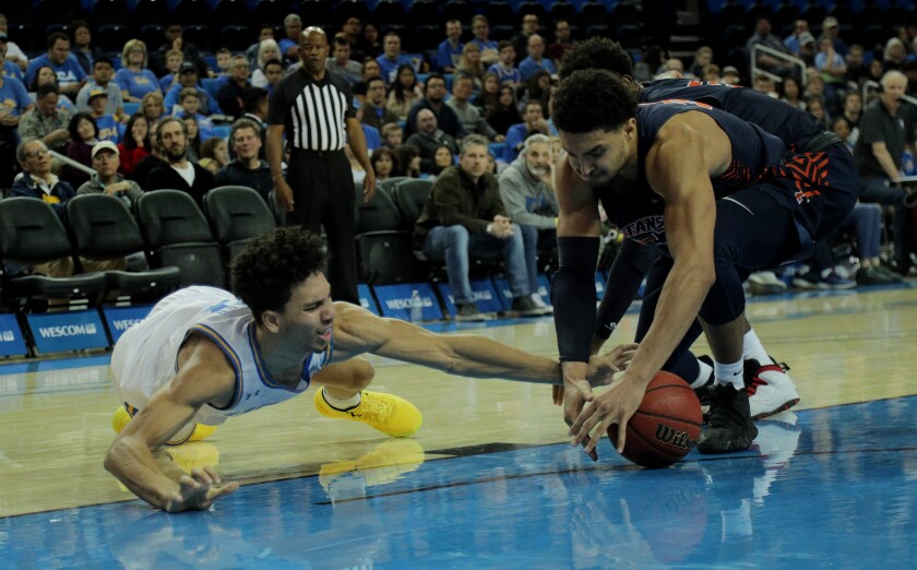 UCLA guard Jules Bernard (3) loses the ball to Cal State Fullerton forward Jackson Rowe during a game Dec. 28 at Pauley Pavilion.