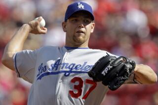 Los Angeles Dodgers pitcher Charlie Haeger throws to a Cincinnati Reds in 2009.