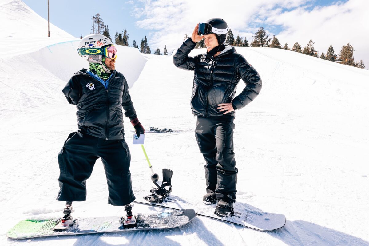 Triple amputee Zach Sherman, left, with snowboarding legend Shaun White in Park City, Utah.
