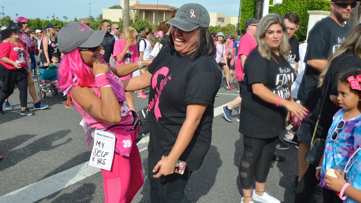 Cancer survivor Sonia Briseno, left, and Nancy Bogdanoff, who is in treatment, embrace during the More than Pink Walk held Sunday in Newport Beach to benefit breast cancer research.