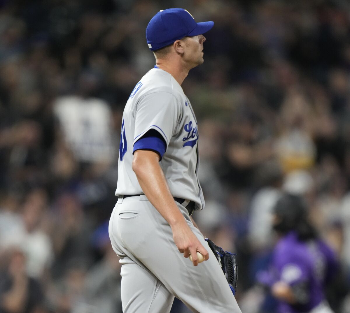 Los Angeles Dodgers relief pitcher Blake Treinen, front, reacts after giving up a solo home run.