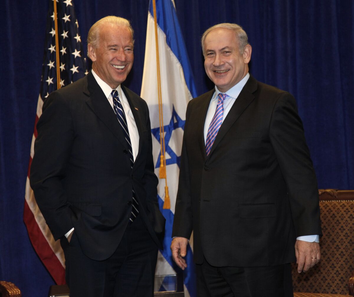 Joe Biden, left, with Israeli Prime Minister Benjamin Netanyahu in front of U.S. and Israeli flags