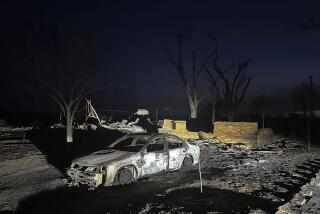 FILE - A charred vehicle sits near the ruins of a home after the property was burned by the Smokehouse Creek Fire, Wednesday, Feb. 28, 2024, in Fritch, Texas. Fritch Fire Chief Zeb Smith, whose small town was among the hardest hit last week by historic blazes sweeping across the Panhandle, died Tuesday, March 5, 2024, while fighting a structure fire, authorities said. (AP Photo/Ty O'Neil, File)