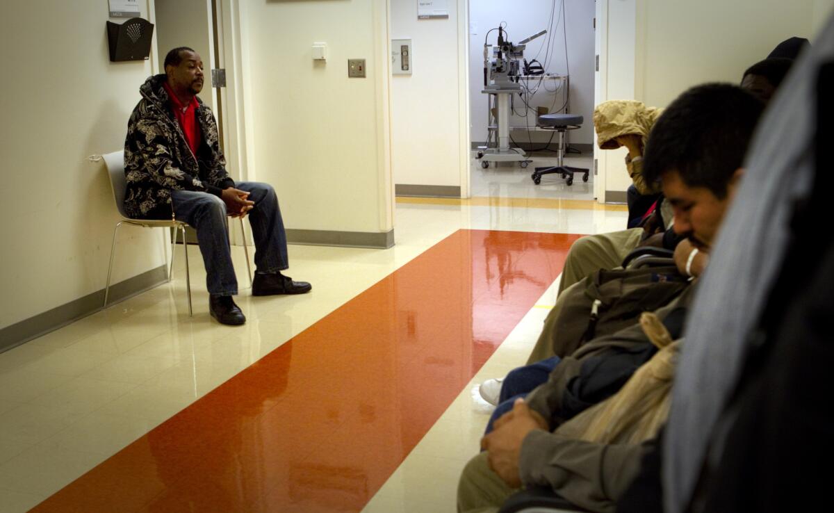 A man sits in a waiting room Los Angeles County/USC Medical Center in 2012.