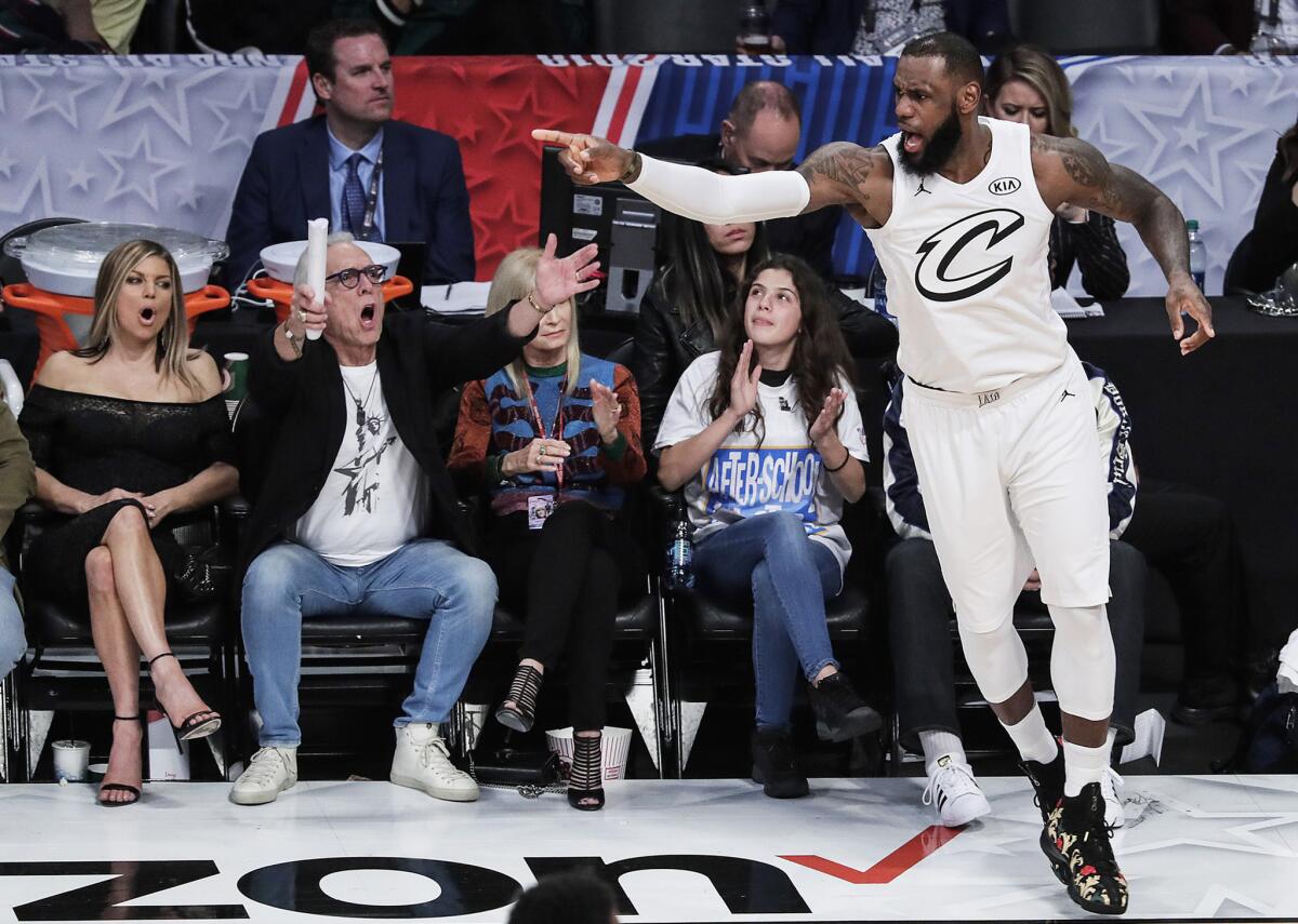 LeBron James reacts after making a three-pointer late in the second half at the NBA All-Star game at Staples Center.