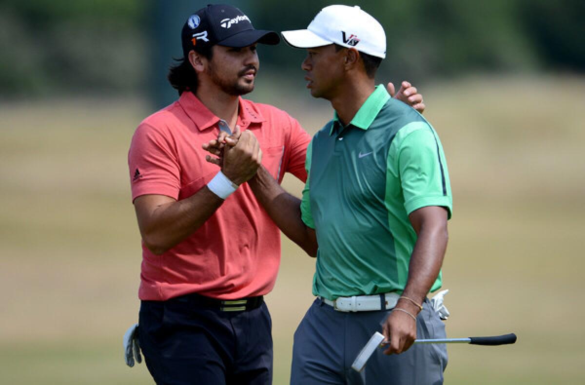 Tiger Woods is greeted by Jason Day during a British Open practice at Muirfield.
